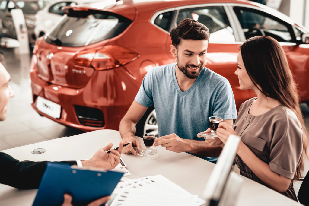 a young couple are comparing car loans