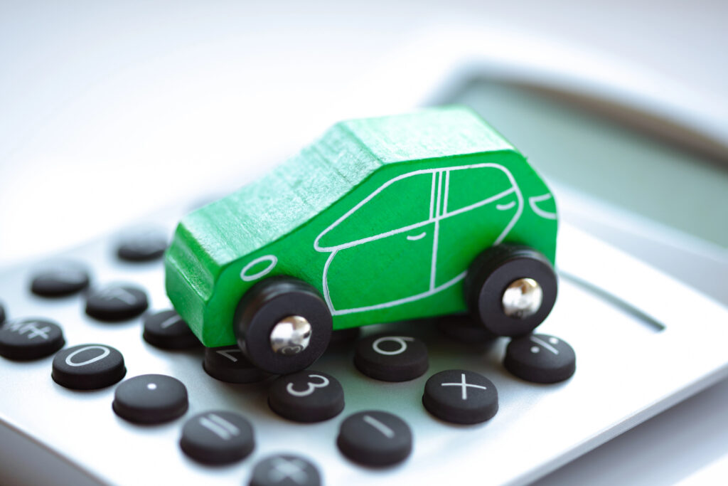 a green toy car and calculator